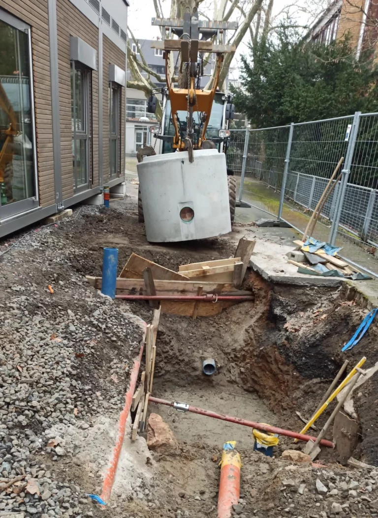 Einsetzen eines Betonschachtes bei Medienerschließung an der Uhlandschule Frankfurt – Suppro GmbH